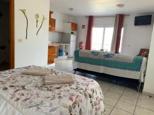 a kitchen with two beds in a room at Apartamentos Mar Azul Arinaga in Arinaga +38 photos