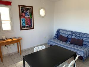a living room with a couch and a table at Mar Azul Arinaga in Arinaga