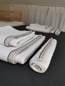 a group of white towels sitting on a table at VUKAJLO apartment Belgrade in Belgrade +81 photos