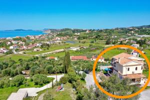 an aerial view of a house with an orange circle on it at Luxury Villa Makris with private heatable pool in Kavvadádes