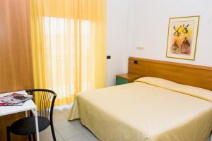 A bed or beds in a room at Residence Il Monello