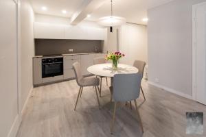 a kitchen with a table and chairs in a room at COME2rest - Smilga in Juodkrantė