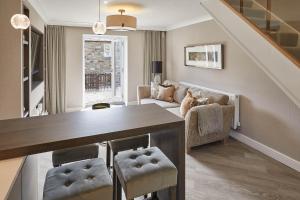 a dining room with a table and chairs and a living room at Host & Stay - Priory Yard, Barnard Castle in Barnard Castle