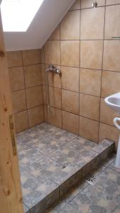 a bathroom with a sink, toilet, and bathtub at Alpine Escape Studios in Măgura