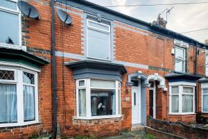 a red brick house with white windows at Contractor and Family House & Free Parking & Garden in Hull