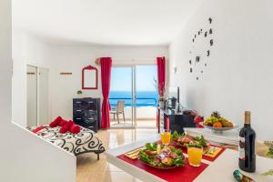a living room with a table with food on it at 1316 Ocean View Studio Paraiso in Playa Paraiso