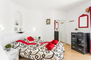 a bedroom with a black and white bed with red pillows at 1316 Ocean View Studio Paraiso in Playa Paraiso +29 photos