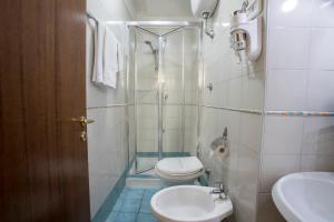 a bathroom with a shower and a toilet and a sink at Dependance in Naples