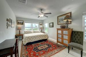 a bedroom with a bed and a table and a chair at Relaxed Beachin in Rockport
