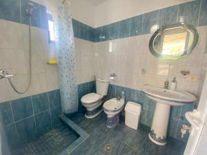a bathroom with a toilet and a sink at Maison Bellevue - 2 bdrm villa in Borsh beach in Borsh