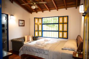 Ένα ή περισσότερα κρεβάτια σε δωμάτιο στο FINCA HOTEL CARMONIA DEL BOSQUE