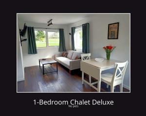 a living room with a couch and a table at Airdeny Chalets in Taynuilt