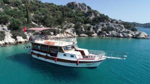 a boat floating in the water next to a island at Kekova Private Boat Tour in Demre