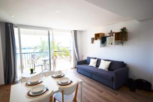 a living room with a couch and a table at Golive Deluxe in Cambrils