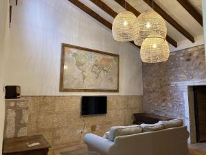 a living room with a couch and two chandeliers at Town House Ca Na Mabel in Sa Pobla in Sa Pobla