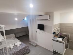 a hospital room with a bed and a tv at Alle Mansarde in Parma