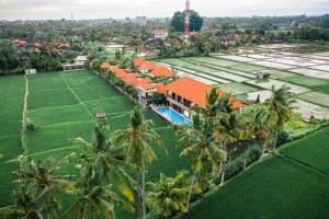 an aerial view of a resort with palm trees at The Sawah Resort & Villa in Ubud