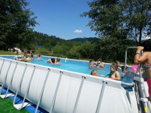a group of people in a swimming pool at Hotel**Pieniny in Niedzica