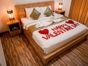 a bed with a happy new year written on it at The Sawah Resort & Villa in Ubud