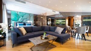 a living room with a blue couch and a bedroom at Espina Hotel in Antalya