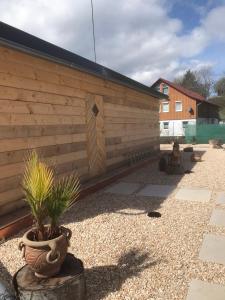 a backyard with a wooden wall and a potted plant at Haus Friedel 2 in Überlingen