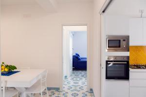 a kitchen with a table and a microwave at Domus Teresia - Amalfi Coast in Furore