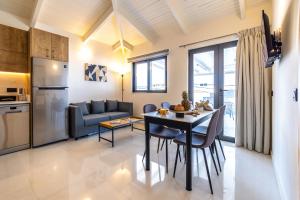 kuchnia i salon ze stołem i krzesłami w obiekcie Astron Aparthotel by Estia w mieście Analipsi