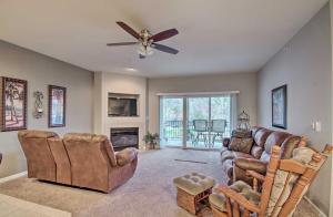 a living room with leather furniture and a ceiling fan at Spacious Lakefront Condo with Community Pools! in Camdenton