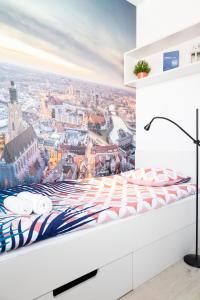 a bedroom with a view of the city at Lumen Studio in Wrocław