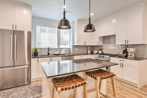 a kitchen with white cabinets and stainless steel appliances at Modern-Chic Provo Townhome 1 Mi to BYU Campus in Provo