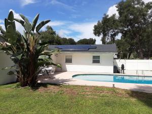a house with a swimming pool in the yard at SPACIOUS POOL HOME in North FL in Keystone Heights