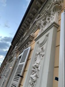 a building with a column with carvings on it at Maria Vittoria House in Turin