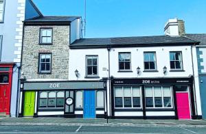 a building with colorful doors on a city street at Zoe Bistro & Accommodation in Kilrush