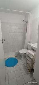 a white bathroom with a toilet and a sink at Largo da Paz 24 in Lisbon