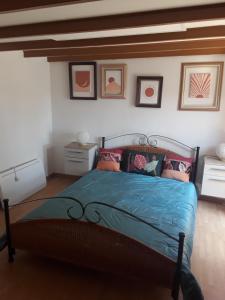 a bedroom with a bed with pillows on it at Un petit coin de paradis in Les Arcs sur Argens