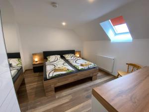 a small room with a bed and a window at Pension Pradler Wohnung Obergeschoß in Carolinensiel