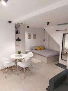a bedroom with a bed and a table and chairs at Casa Gray in Koper