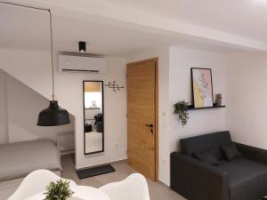 a living room with a couch and a mirror at Casa Gray in Koper