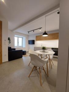 a living room and kitchen with a table and chairs at Casa Gray in Koper
