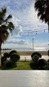 a view of a beach with a string of lights at viki sea view apartment in Durrës