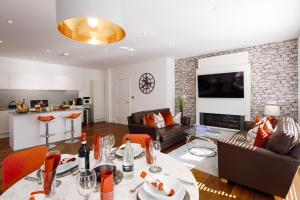 a kitchen and living room with a table and chairs at Springfield Four in Harrogate