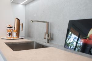 a kitchen counter with a sink and a tv at Springfield Four in Harrogate