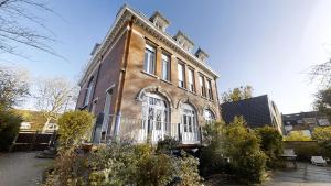 Un gran edificio de ladrillo con un balcón al costado. en Maison Colodge DELORY BARBIEUX, en Roubaix