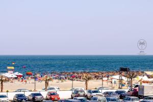 a parking lot at a beach with cars parked at Eqinox apartments in Mamaia Sat/Năvodari