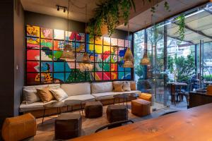 a living room with a couch and a colorful wall at The Place in Santiago
