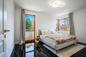 a bedroom with a bed and a window at Serenity Villa Prague with Garden and Jacuzzi in Prague