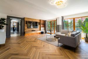 a living room with a couch and a table at Serenity Prague Villa with garden jacuzzi in Prague