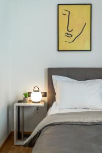 a bedroom with a bed and a side table at Athena Studio in Gazi in Athens