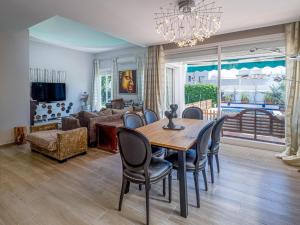 a dining room with a table and chairs and a couch at Villa Happy River in Marbella
