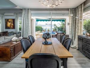 a dining room with a wooden table and chairs at Villa Happy River in Marbella